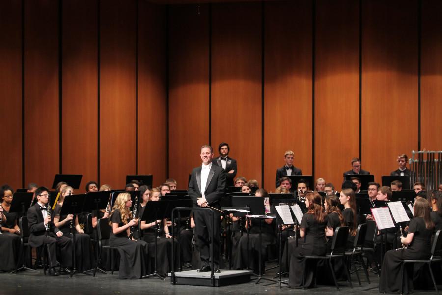 Band director, John Cook, smiles to the audience. 