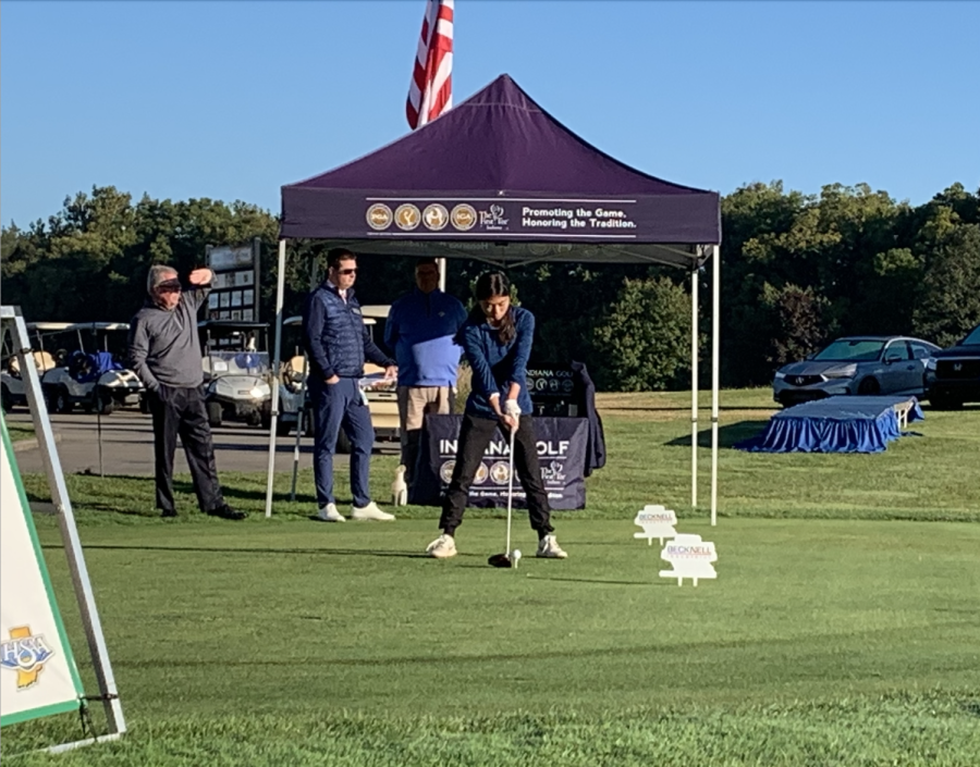 Ready to swing, junior Ella Bui lines her up shot at the girls golf state finals on Oct. 1.