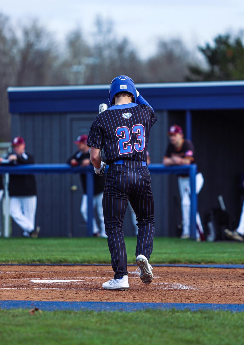 Senior Drew LaFleur walking up to the plate for an at bat.