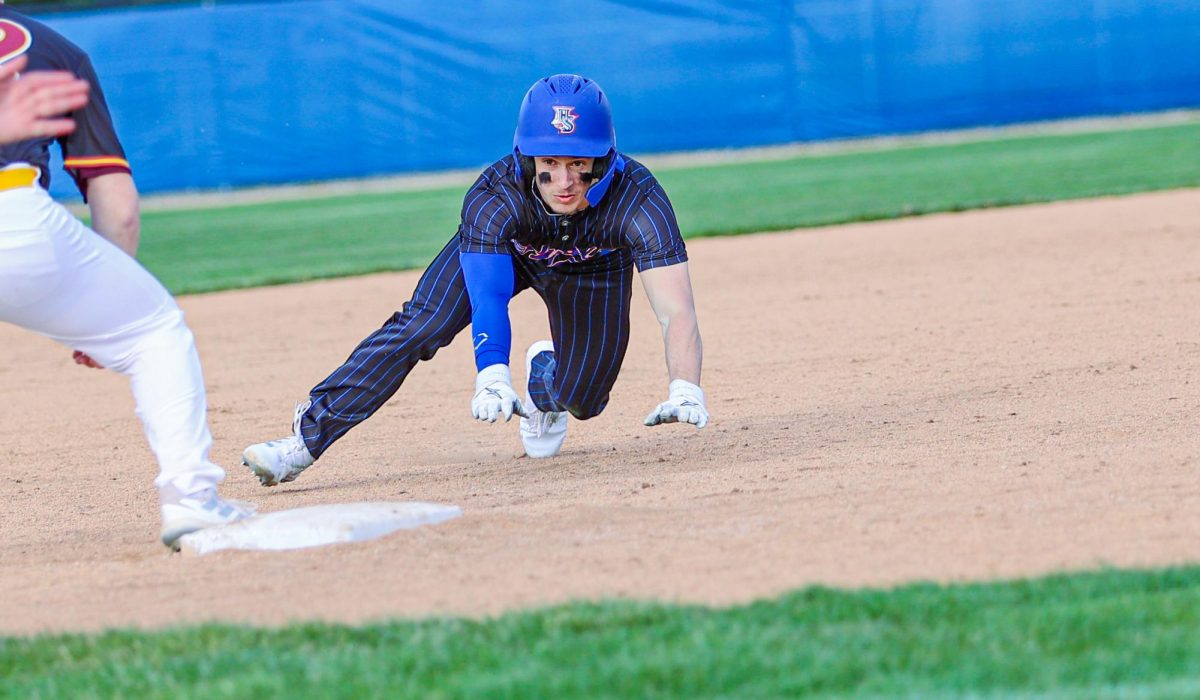 Senior Drew LaFleur sliding into third after hitting a triple