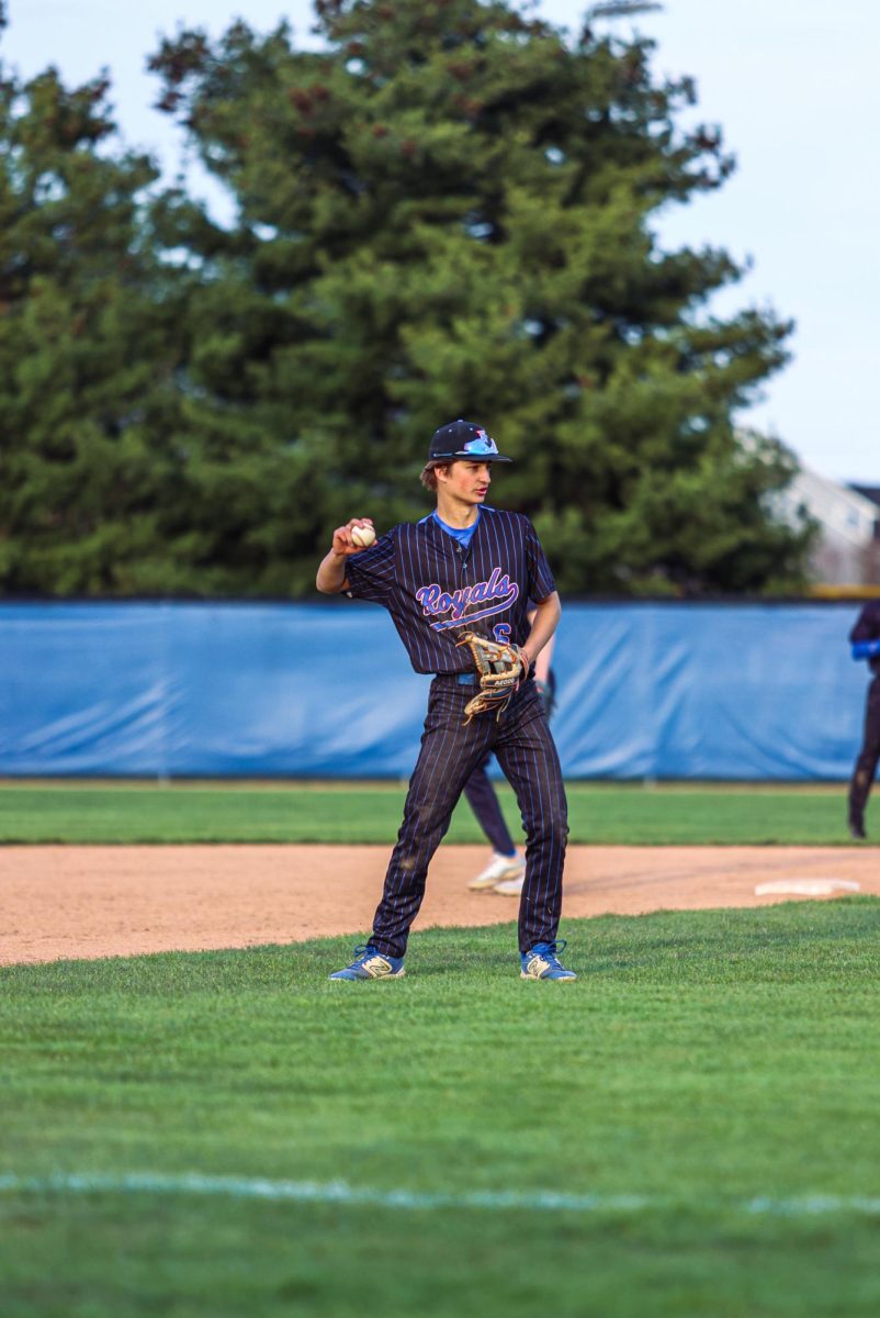 Senior Luke Sivak warming up at third base.