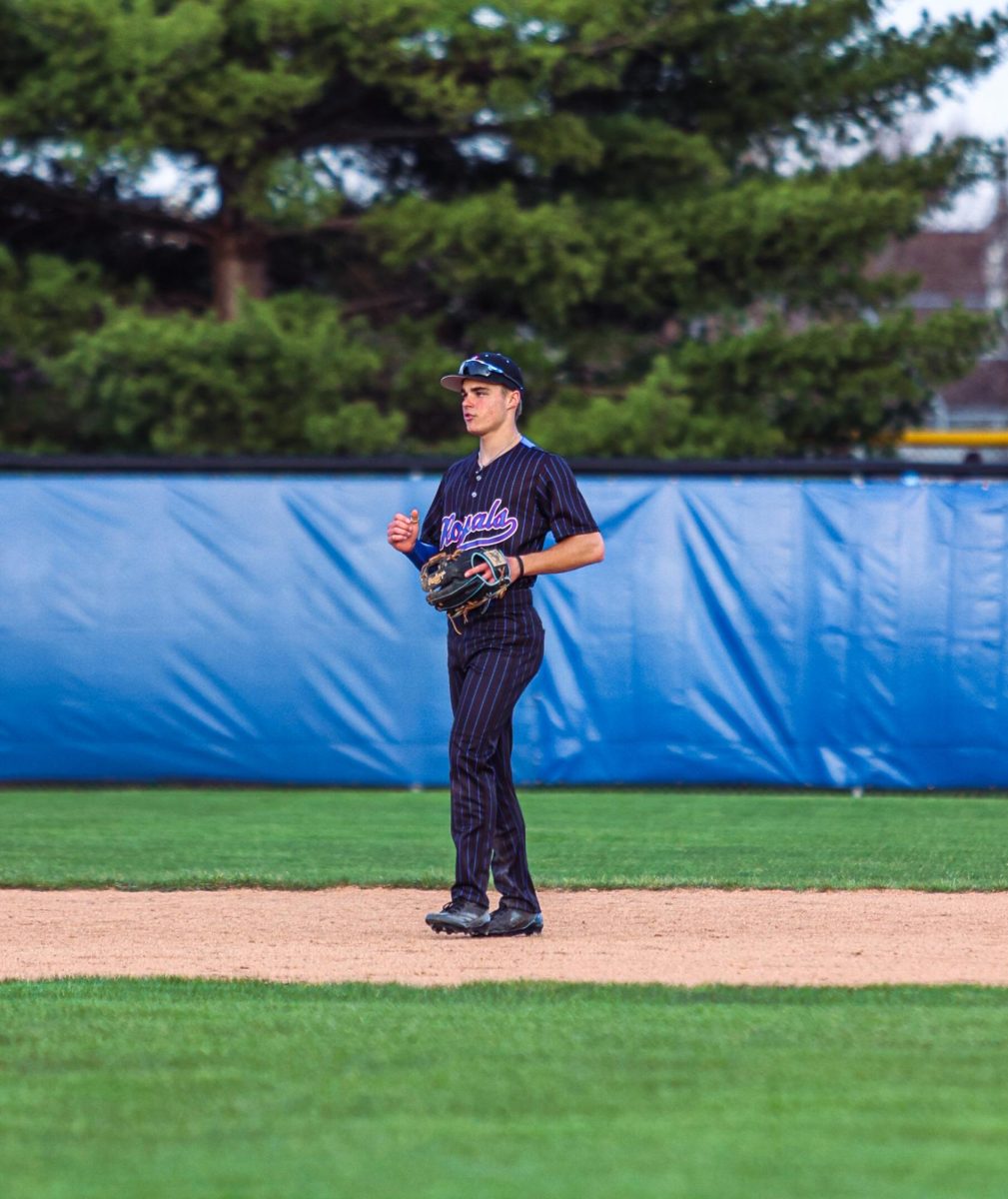 Junior Maddux Bach warming up in the infield.