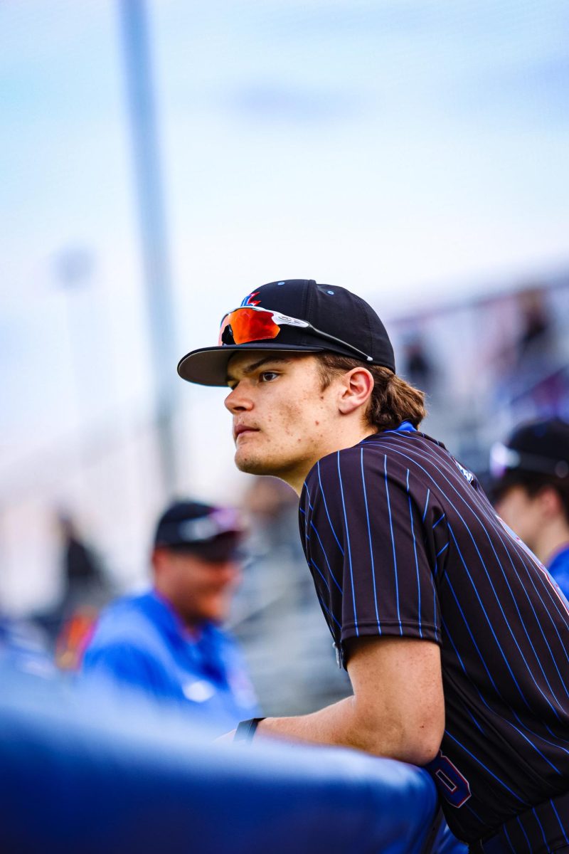 Junior Ty Earlewine in the dug out watching the play.