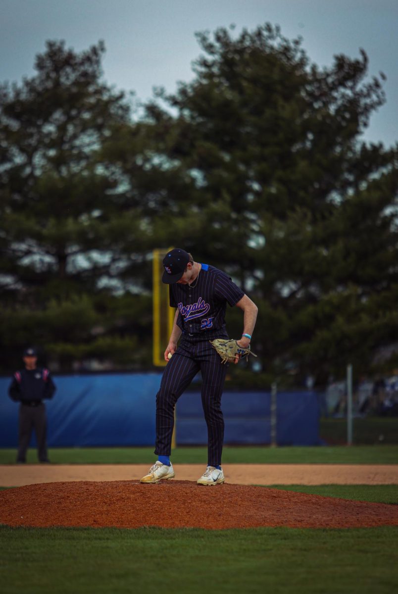 Junior Matt Poyer takes the mound to warm up after pitching change