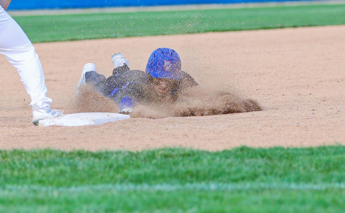 Senior Drew LaFleur sliding into third after hitting a triple