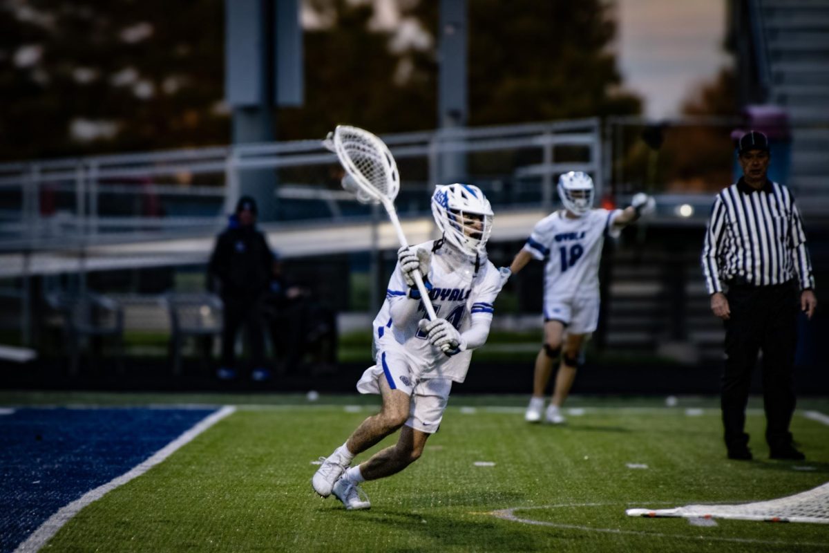 Junior Luke Williams chases after ball gets it and clears it to his teammates