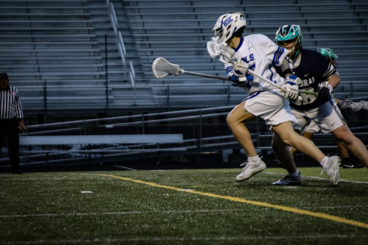 Senior John Pauls runs down the field with the ball to pass to an open player