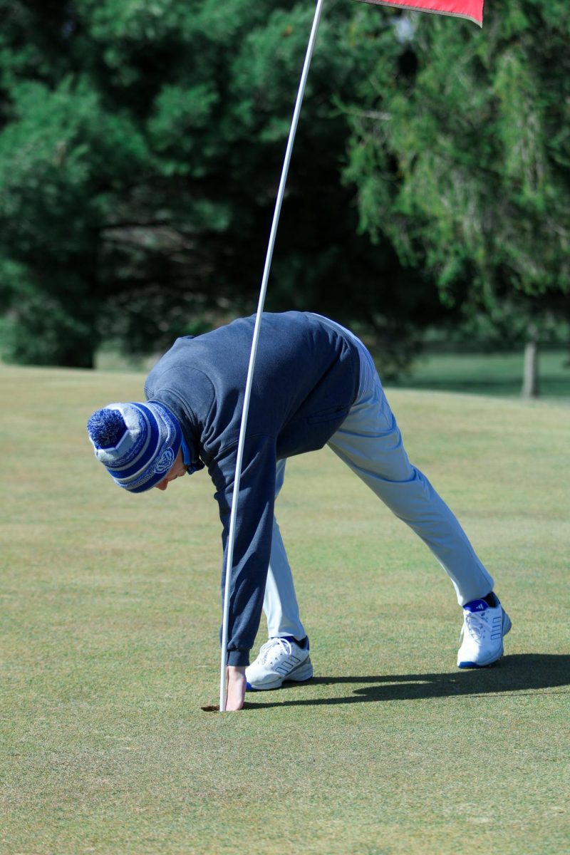 Senior Aiden Huffer Reaches in for his Hole-In-One Ball