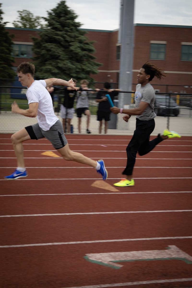 Juniors Liam Boyd and Chandler Weston  practice their pass for the relay race.