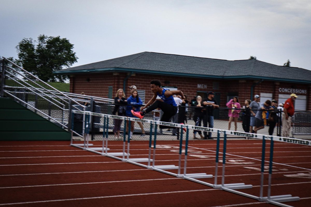 Senior Harold Williams practices his hurdle jumps before the race starts 