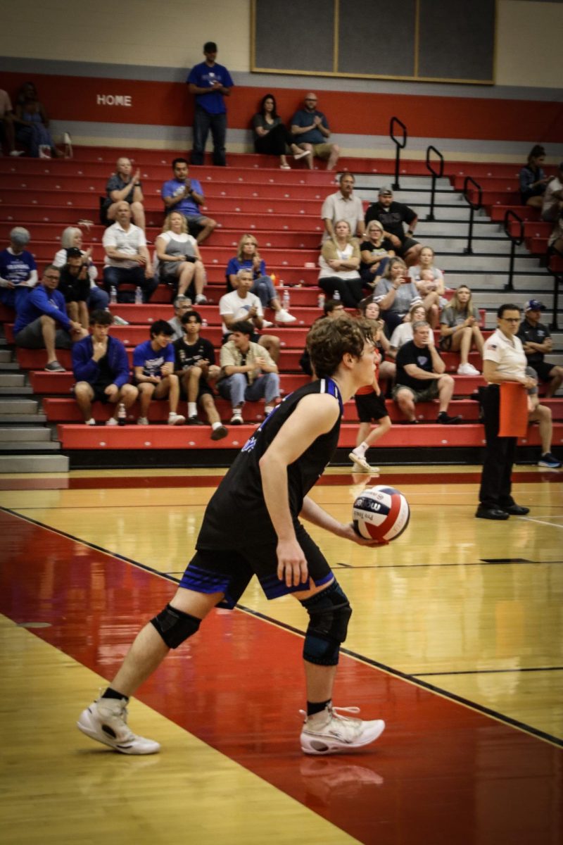 Sean smart is ready and doing a jump serve.