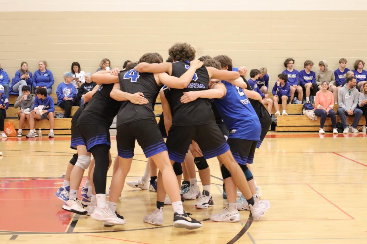 Boys Volleyball team making a game plan.