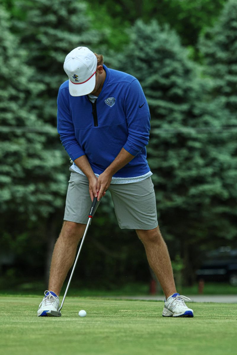 Senior Charlie Putnam putts the ball at Fall Creek Golf Club on May 9th, 2024