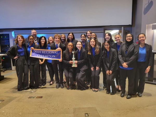 We the People members gathering around their newly won trophy to celebrate their regional win.